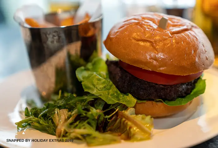 Food selection including a burger and salad in a Birmingham Airport lounge