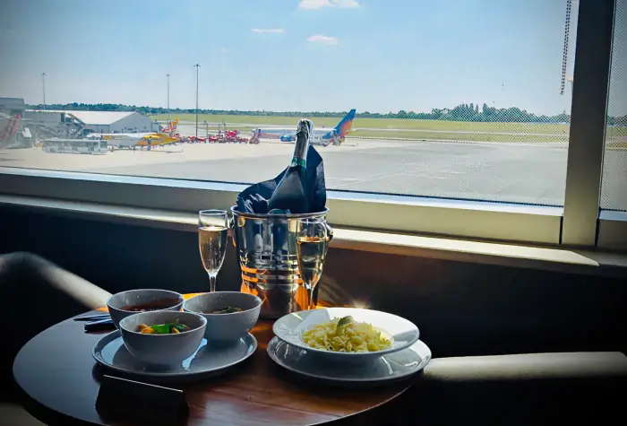 Plate of food served with runway views in a Birmingham Airport lounge