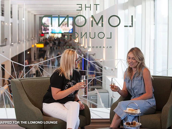Guest seated at the bar in The Lomond Lounge at Glasgow Airport