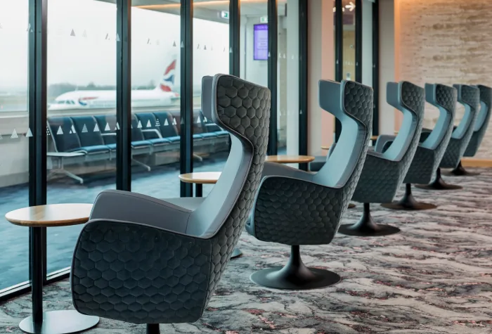 Window-side lounge seating with runway views at Newcastle Airport