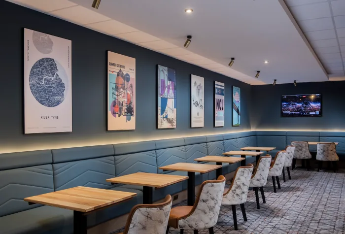 Dining tables and seating inside the Aspire Lounge at Newcastle Airport