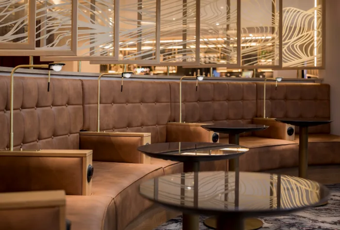 Curved sofa seating inside the Suite by Aspire lounge at Newcastle Airport