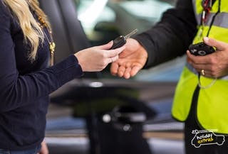Manchester Airport Meet and Greet - the image shows a customer handing their car keys to the professional driver who will park their car for them