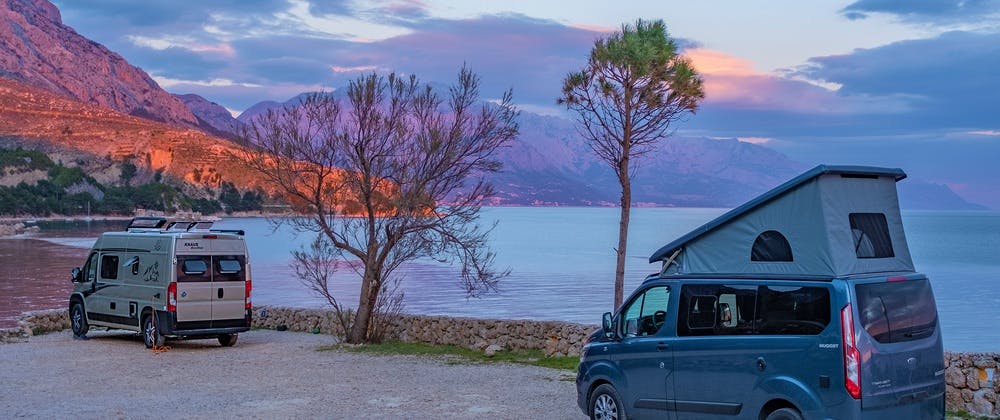 Converted campervans next to a pretty lake