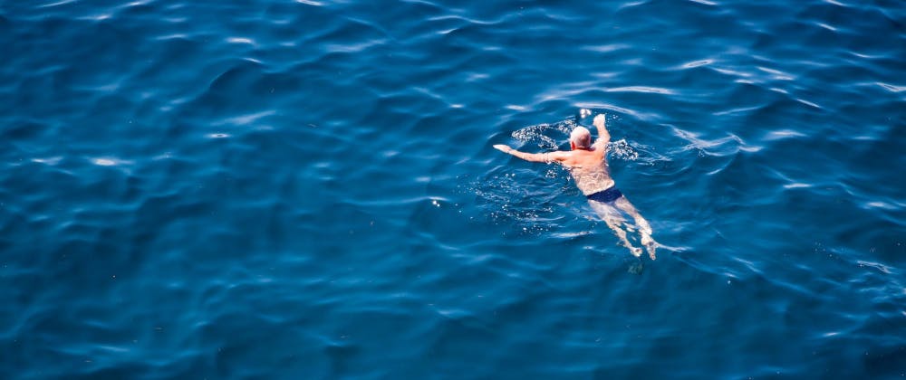 Man in Speedos swimming in the sea in Dubrovnik, Croatia