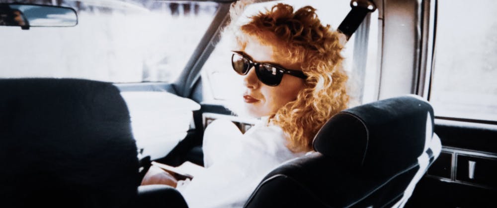 Lady with big hair and sunglasses