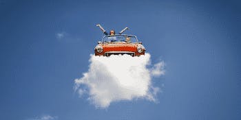 Car in the sky resting on a cloud