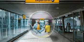 Hassle-free holiday hub | Man in lotus pose floating in a bubble in an airport