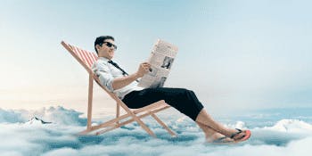 All the latest travel news | Man reading the news on a deckchair in the sky