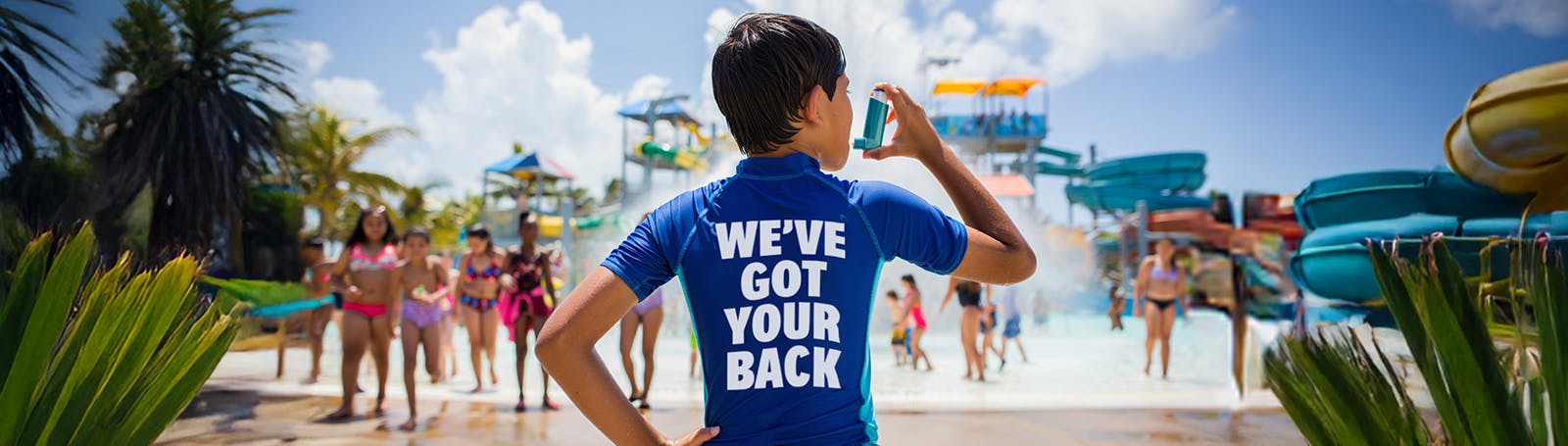 Older man relaxing on a beach at sunset with arms outstretched, enjoying his holiday with suitable travel insurance for asthma.