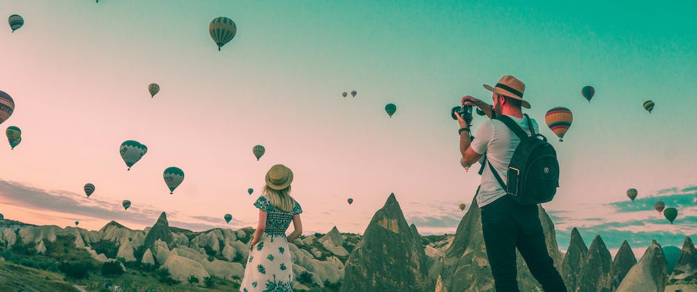 A couple enjoying the hot air balloons in Cappadocia, Turkey