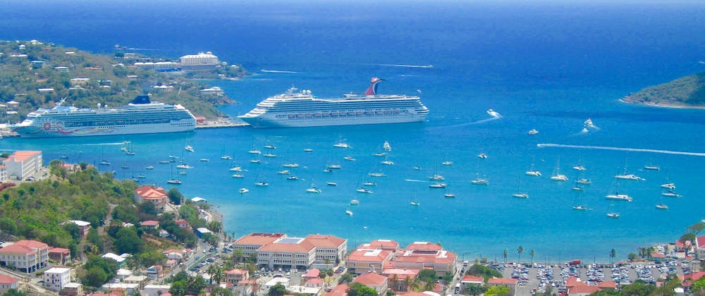 Two cruise ships docked in a picturesque holiday resort