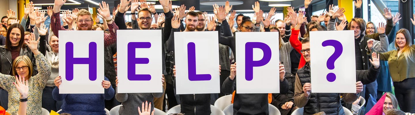 Holiday Extras staff holding up a help sign