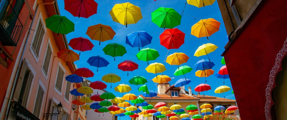 colourful umbrellas addorning a rustic street