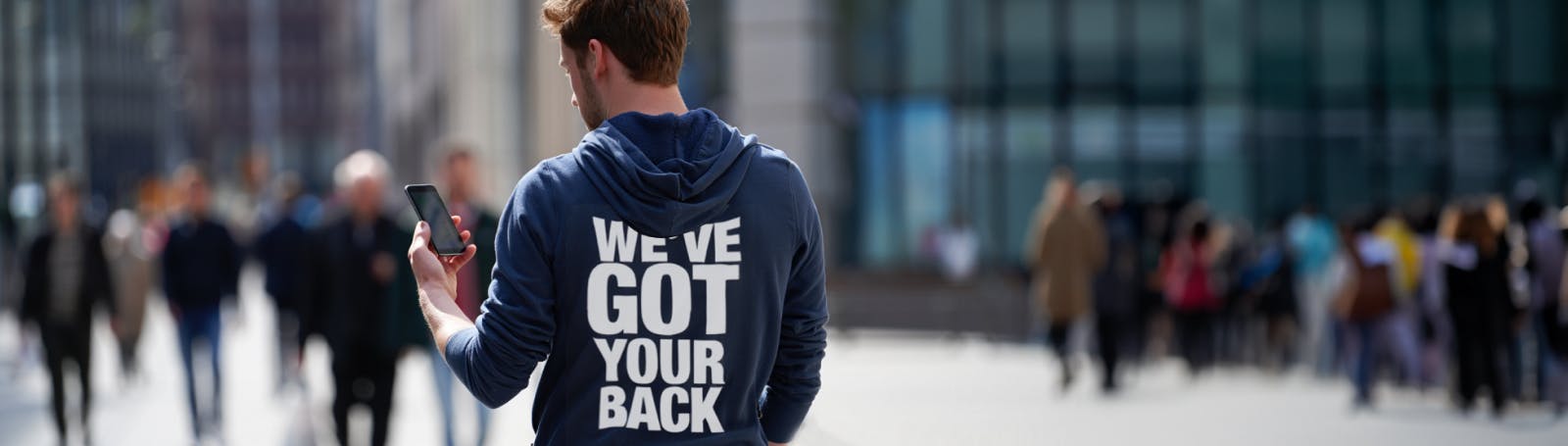 A person wearing a hoodie with the words