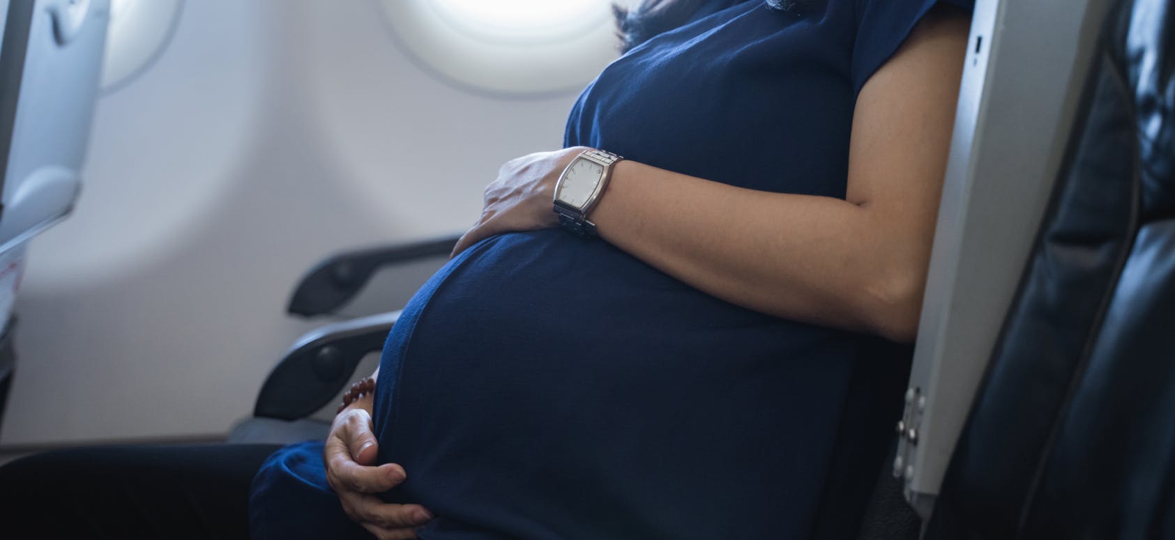 Pregnant traveller on a plane.