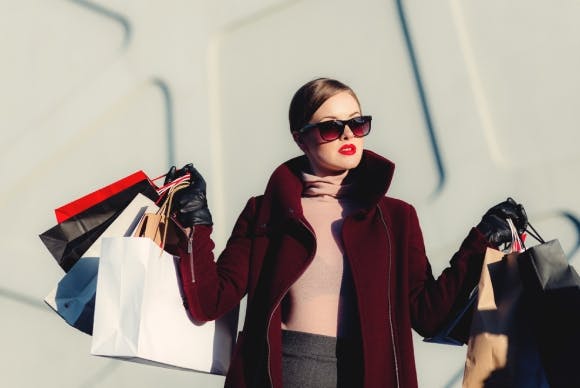 Woman on shopping spree in city with multiple bags