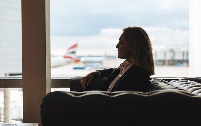 Club Aspire Heathrow Terminal 3 Lounge Woman enjoying runway views