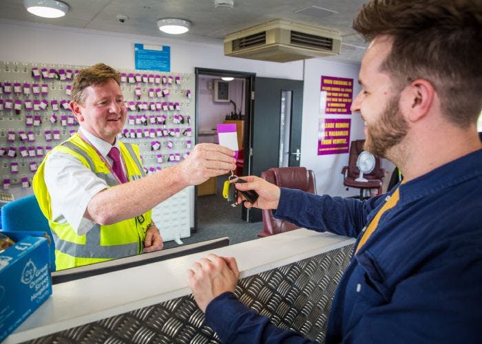 Passenger collecting car keys at Purple Parking Gatwick after return flight