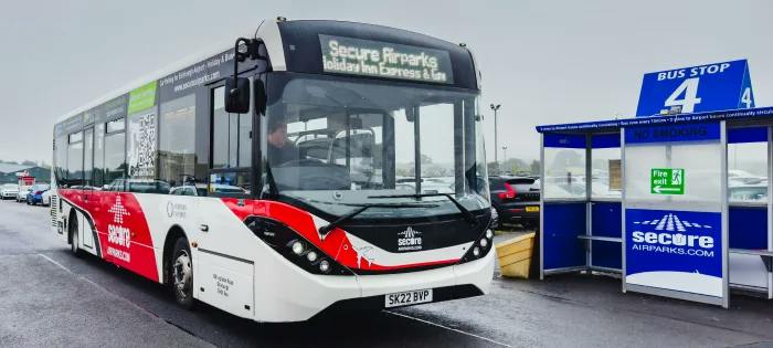 Secure Airparks shuttle bus beside its bus shelter at Edinburgh Airport